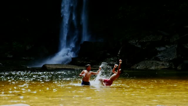 Rural-children-practicing-Muay-Thai-at-waterfall.-(Slow-motion)