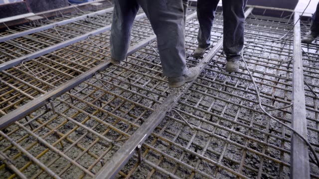 Workers-and-engineers-pour-foundation.-Tons-of-concrete-and-reinforcement-form-a-solid-monolithic-compound