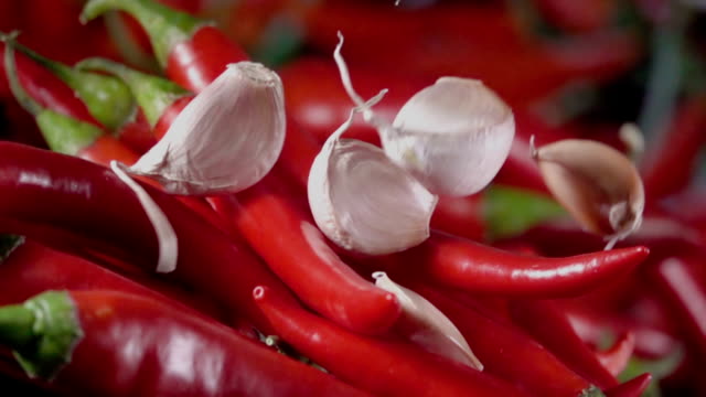 Falling-of-garlic-into-the-red-hot-pepper.-Slow-motion-480-fps