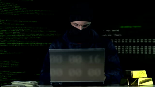 Criminal-in-balaclava-working-on-laptop,-hacking-bank-security-system,-data-code