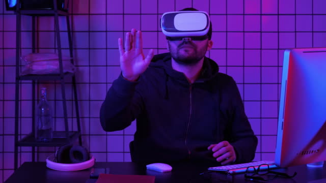 Young-handsome-man-wearing-virtual-reality-glasses-manipulating-vr-objects