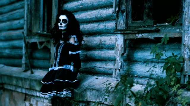 The-young-woman-with-make-up-for-Halloween-standing-in-front-of-wooden-wall.-4K