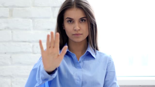 Portrait-of-Beautiful-Young-Woman-Gesturing-Stop-Sign-with-Hand