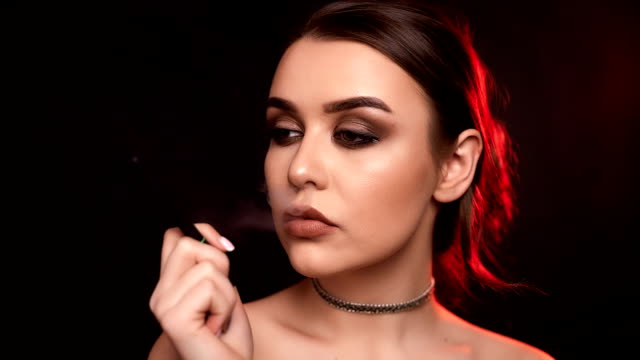 Glamour-seductive-gorgeous-brunette-woman-smoking-electronic-cigarette