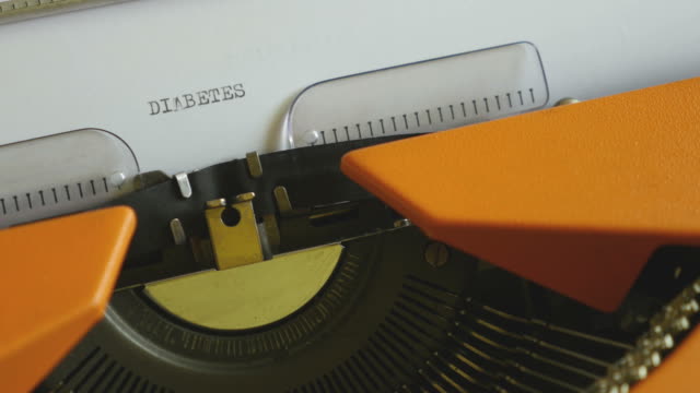 Close-up-footage-of-a-person-writing-DIABETES-on-an-old-typewriter