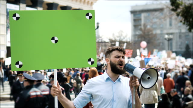 Europäische-Menschen-bei-Demonstration.-Mann-mit-einem-Banner-schreien-in-ein-Mundstück.