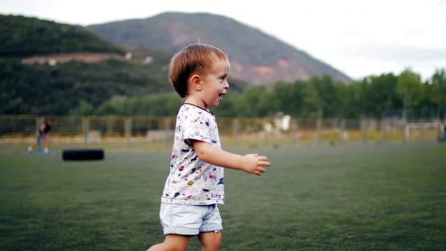 Nicht-identifizierte-Kinder-spielen-Fußball-auf-dem-Hintergrund-des-Sonnenuntergangs.-Slow-Motion.