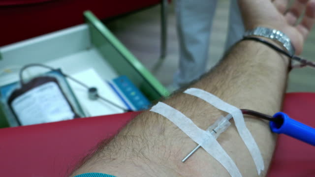 A-person-donating-blood-at-the-transfusion-department...