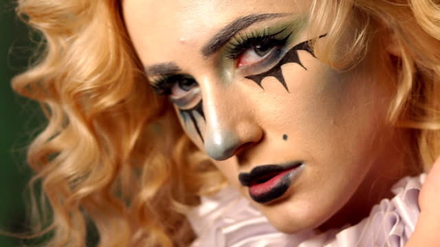 Close-up-portrait-of-an-excited-blonde-woman-with-make-up-in-halloween.