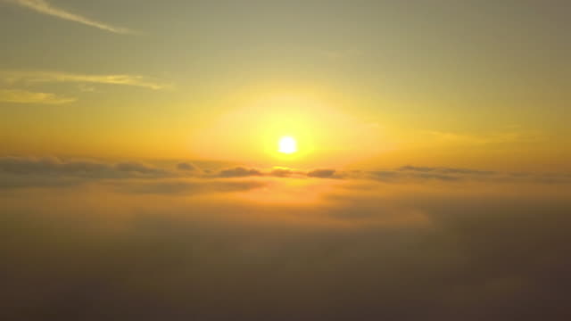 Flying-moving-over-the-clouds-tranquil-with-golden-sun-in-forenoon.