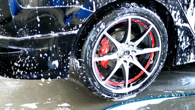 Car-with-white-soap-on-the-body.-car-wash-concept.-Slow-motion