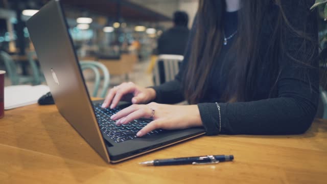 Closeup-view-of-woman-Hands-typing-on-a-laptop-keyboard