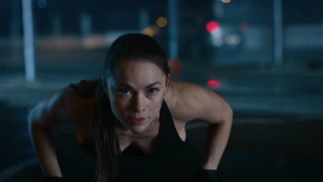 Beautiful-Sporty-Fitness-Girl-Doing-Push-Up-Exercises.-She-is-Doing-a-Workout-in-a-Fenced-Outdoor-Basketball-Court.-Night-Footage-After-Rain-in-a-Residential-Neighborhood-Area.