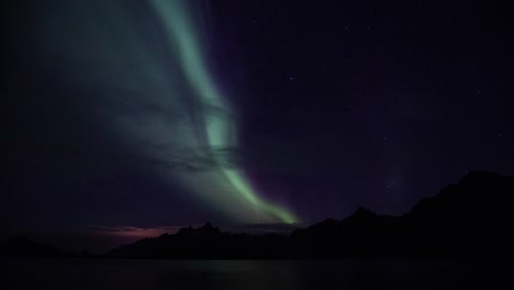 Time-lapse-of-northern-lights-(aurora-borealis)-over-Trollfjord-on-Lofoten-islands,-Norway