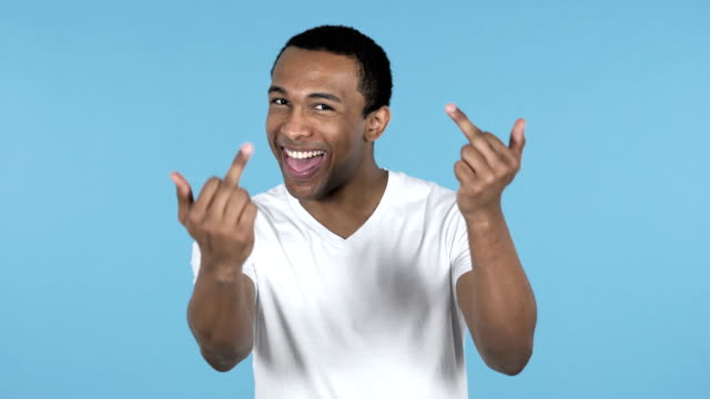 Happy-African-Man-Showing-Middle-Fingers-Isolated-on-Blue-Background
