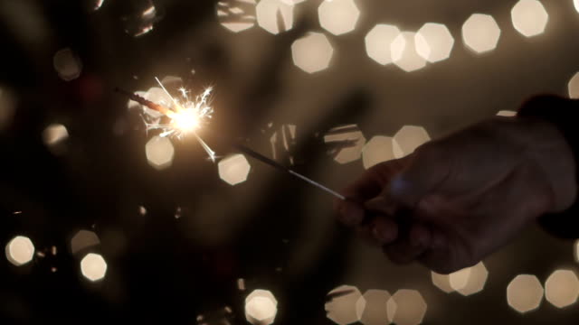 Hand-girl-with-sparkler-in-celebrate-party-at-home