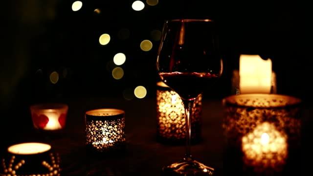 Wine-pouring-into-a-glass-on-the-background-of-Christmas-tree-in-the-evening-dark.-New-Year-holidays-beverage-concept-image.