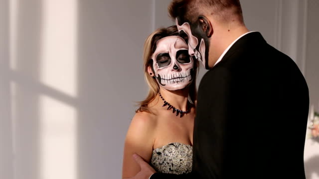 A-man-and-a-woman-in-a-dress-and-costume-with-a-creepy-Halloween-makeup.