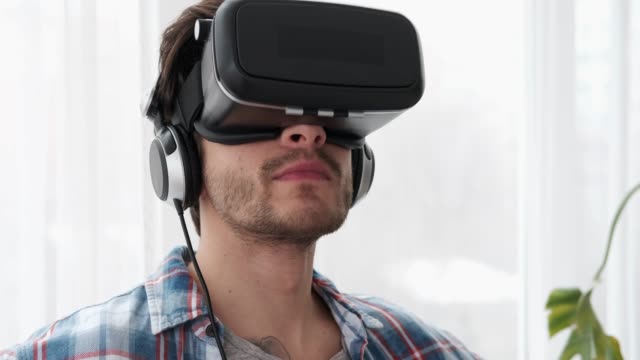 Young-man-wearing-virtual-reality-device
