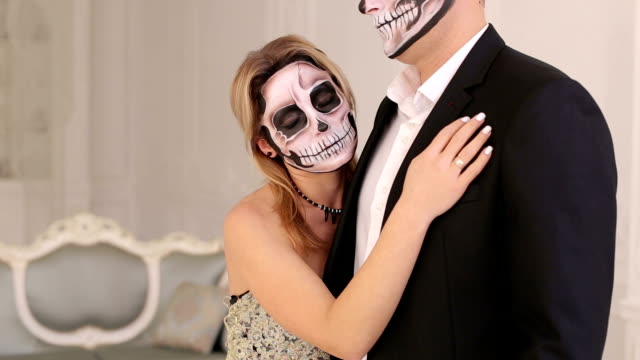 Halloween.-A-couple-with-makeup-on-their-face-in-a-room-with-a-vintage-interior.