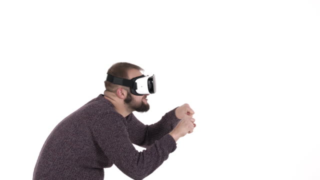 Man-imitates-driving-car-in-virtual-reality-glasses.-Cool-high-tech-devices-usage-concept.