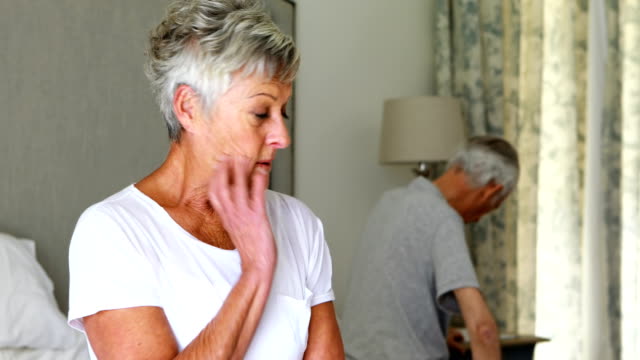 Upset-senior-couple-arguing-with-each-other-in-bedroom