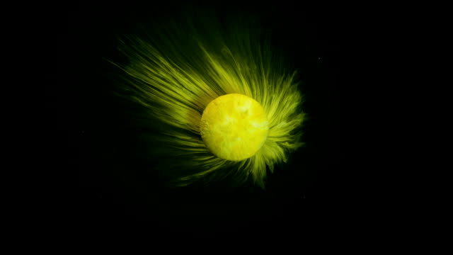 Slow-motion-of-yellow-effervescent-pill-seems-a-shiny-planet-in-the-galaxy-abstract-background