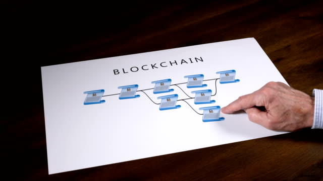 Senior-technologist-pointing-to-blockchain-illustration