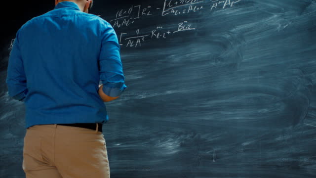 Time-Lapse-of-the-Brilliant-Young-Mathematician-Writing-Formula-on-the--Blackboard.