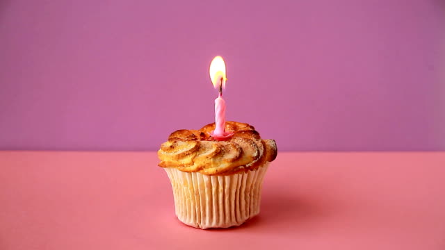 Cupcake-with-one-lighted-candle-for-the-birthday.-Time-lapse-video
