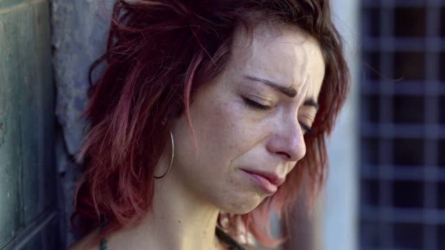 Close-Up-Portrait-Of-Sad-Young-Woman-Crying.-Outdoors