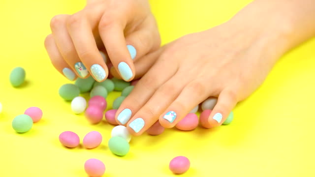 Colorful-candies-and-woman-manicured-hands.