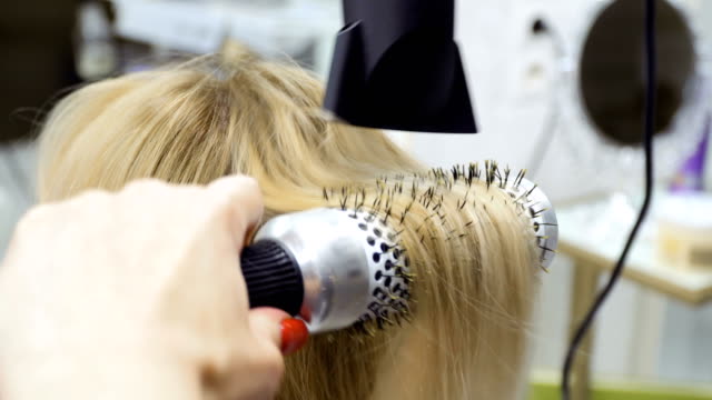 Process-of-making-hairstyle-with-hairdryer-and-brush