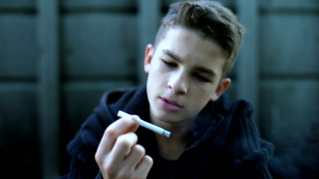 Boy-smoking-cigarette,-influence-of-street-and-bad-company,-childrens-protest