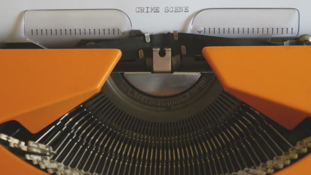 Close-up-footage-of-a-person-writing-CRIME-SCENE-on-an-old-typewriter,-with-sound...