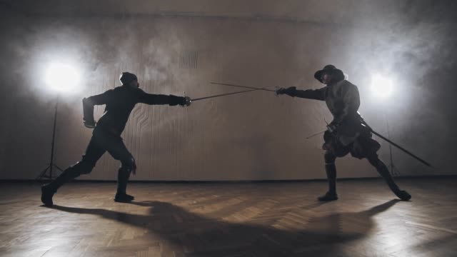 Medieval-warriors-are-fighting-during-sword-battle-indoors-in-slow-motion