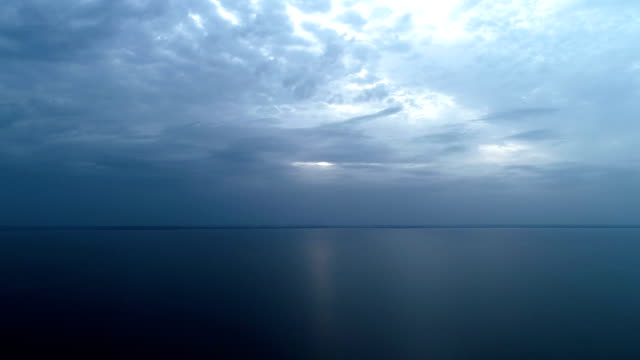 The-flight-above-the-beautiful-sea-on-the-rainy-cloud-background.-time-lapse