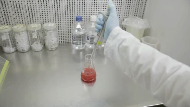 A-researcher-transfer-samples-to-smaller-vials-in-a-genetic-laboratory-at-university