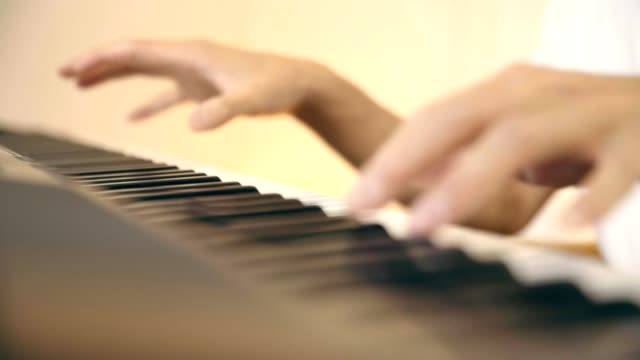 junge-asiatische-Musiker-spielen-Tastatur