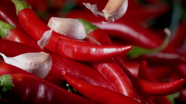 Falling-of-garlic-into-the-red-hot-pepper.-Slow-motion-240-fps