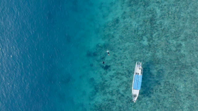 Two-People-Snorkelling-in-Clear-Waters-with-Corals