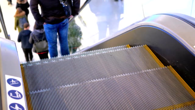 Legs-of-People-Moving-on-an-Escalator-Lift-in-Shopping-Center.-Slow-Motion