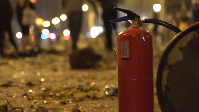 Fire-extinguisher-in-the-destroyed-streets-of-a-city-after-a-violent-clash-with-the-police