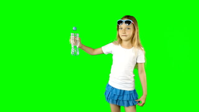 Young-caucasian-girl-is-holding-in-outstretched-hand-bottled-still-water.-Girl-speaking-and-laughing.-Clip-contains-solid-green-instead-alpha-channel.