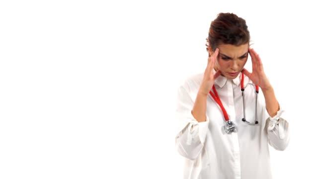 Stressed-surgeon.-Depressed-young-doctor-touching-her-head-with-hands-and-keeping-eyes-closed-while-walking-isolated-on-white-background