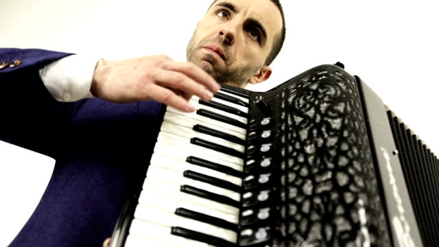 Serious,-focused-musician-in-a-fashionable-suit-enjoys-playing-the-accordion.