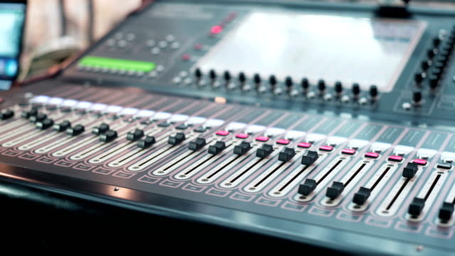 audio-mixer-in-a-studio,-the-automatic-knobs-moving-up.-ready-for-the-recording