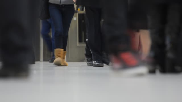 Vista-de-ángulo-bajo-de-personas-caminando-al-lado-de-metro-en-Londres