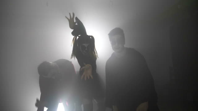 Halloween-zombie-squad-walking-from-fog-to-village-scaring-the-people-in-slow-motion