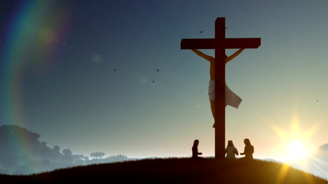 Christians-praying-at-Jesus-cross-at-sunset